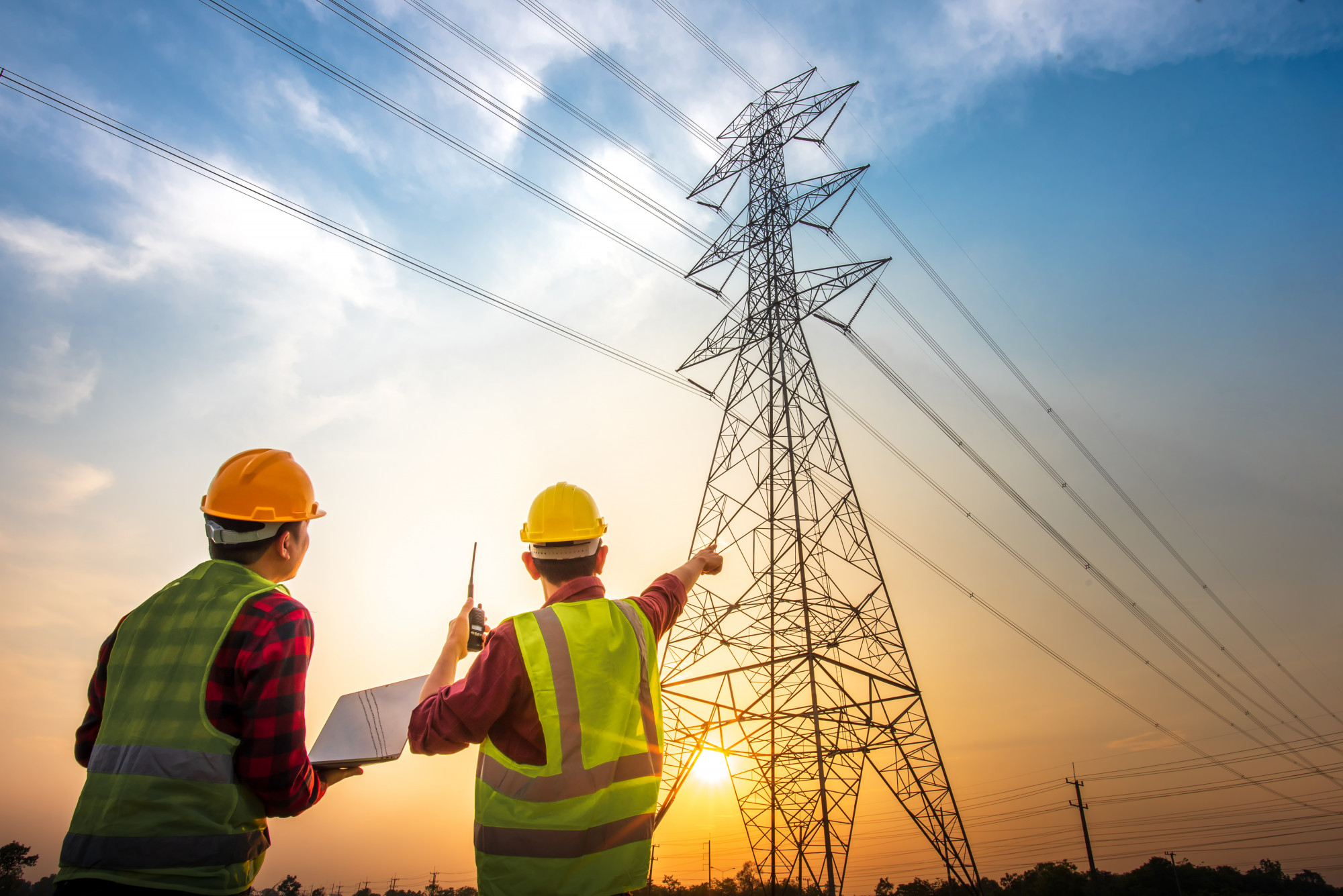 picture-two-electrical-engineers-checking-electrical-work-using-computer-standing-power-station-see-planning-work-high-voltage-electrodes